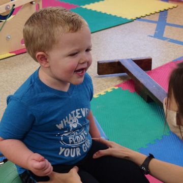 sensory solutions physical therapy. A young boy playing with his physical therapist