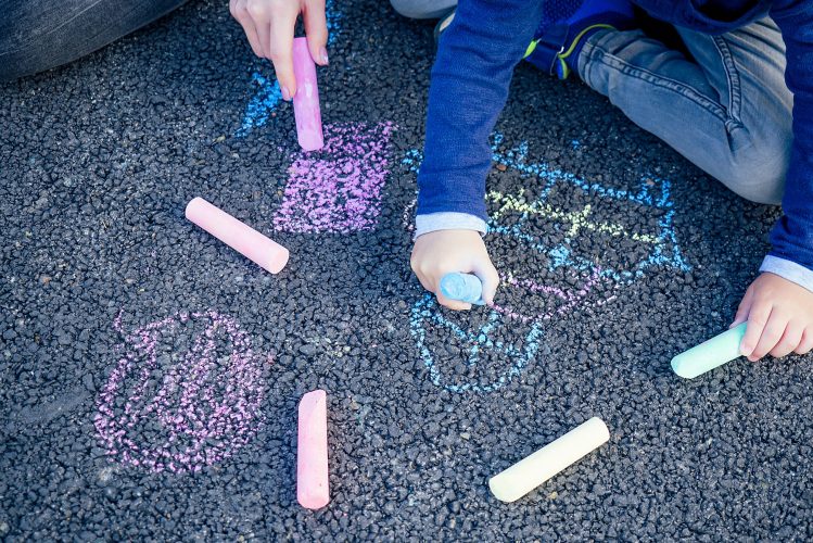 children playing outdoors with chalk