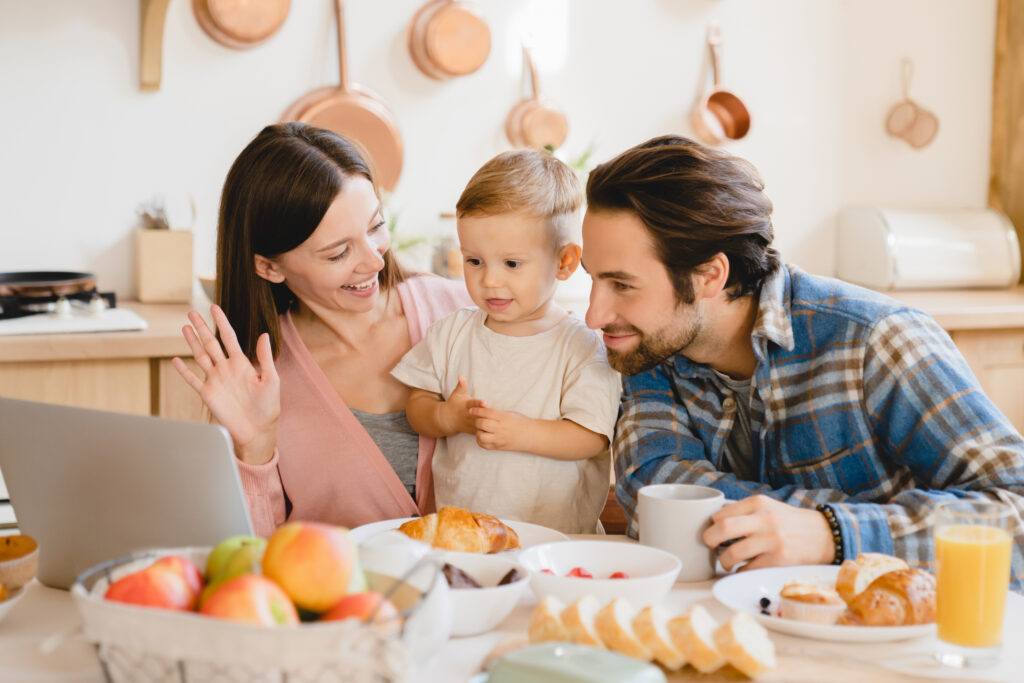 Parents helping teach their toddler how to communicate